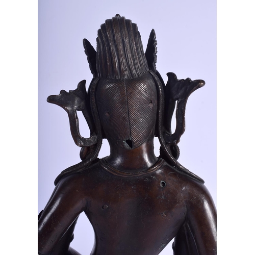 1393 - A GOOD 19TH CENTURY CHINESE NEPALESE INDIAN BRONZE FIGURE OF A DEITY modelled holding stupa and othe... 