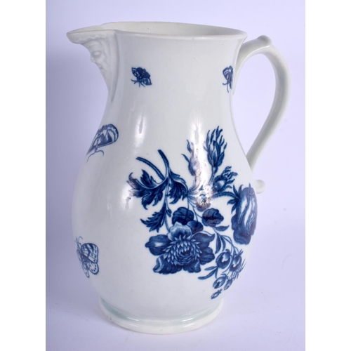 140 - 18th c. Worcester mask jug decorated in blue with flowers and moths. 19 cm high