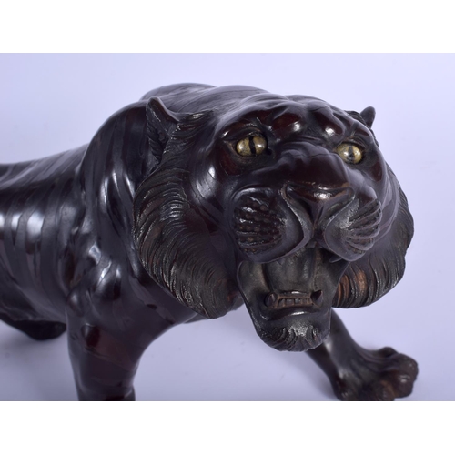 1404 - A 19TH CENTURY JAPANESE MEIJI PERIOD BRONZE OKIMONO OF A TIGER modelled roaming with glass eyes. 50 ... 