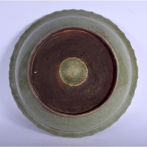 1408 - A VERY LARGE CHINESE CELADON SCALLOPED CHARGER probably Late Qing, decorated with a central emblem. ... 