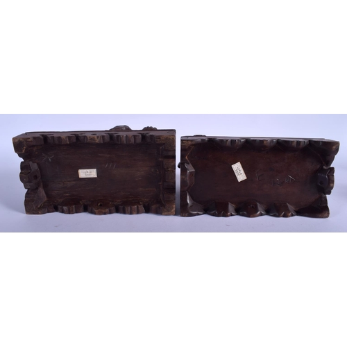 1422 - A PAIR OF EARLY 20TH CENTURY CHINESE HARDWOOD BUDDHISTIC DOGS upon rectangular bases. 22 cm x 20 cm.