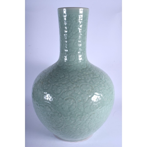 1432 - A LARGE 19TH CENTURY CHINESE CARVED TIAN QIU PING CELADON PORCELAIN VASE Qing, decorated with foliag... 