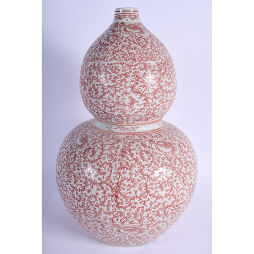 1493 - A RARE EARLY 20TH CENTURY CHINESE IRON RED DOUBLE GOURD VASE painted with stylised flowers. 44 cm x ... 