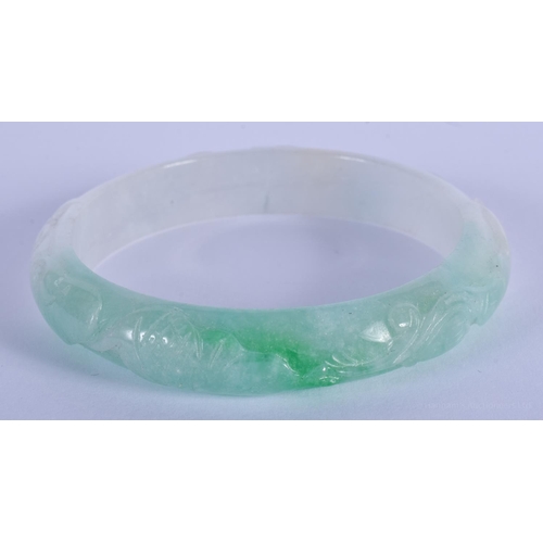 1497 - A CHINESE CARVED JADEITE BANGLE 20th Century. 7 cm diameter.