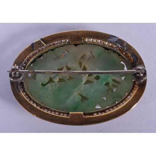 1505 - AN EARLY 20TH CENTURY CHINESE GOLD ENAMEL AND JADEITE BROOCH carved with a bird. 4 cm x 3.25 cm.