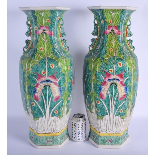 1518 - A LARGE PAIR OF CHINESE TWIN HANDLED FAMILLE ROSE PORCELAIN VASES 20th Century, painted with moths a... 