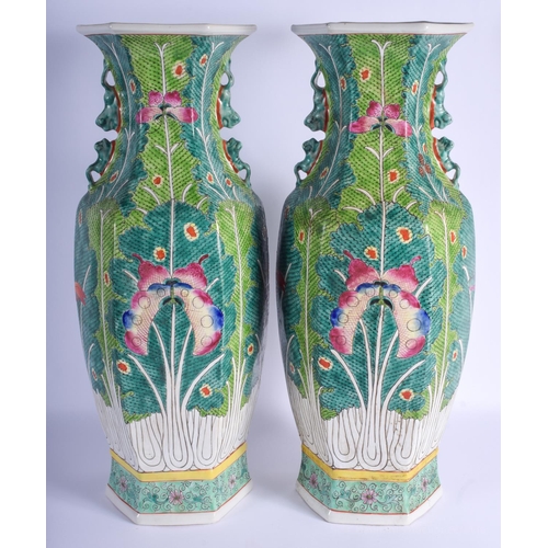 1518 - A LARGE PAIR OF CHINESE TWIN HANDLED FAMILLE ROSE PORCELAIN VASES 20th Century, painted with moths a... 