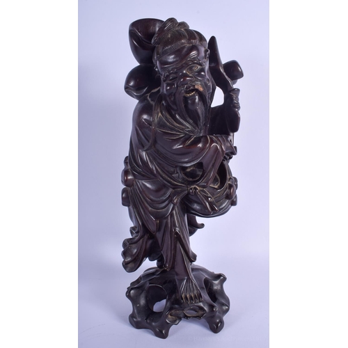 1526 - A 19TH CENTURY CHINESE CARVED ROOT WOOD FIGURE OF AN IMMORTAL modelled upon a rocky outcrop. 39 cm h... 