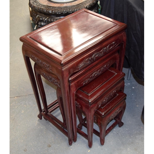 1637 - A NEST OF FOUR CHINESE RED WOOD TABLES 20th Century. Largest 66 cm x 50 cm. (4)