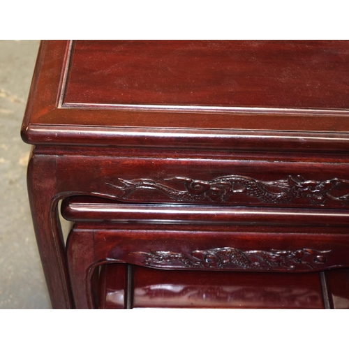 1637 - A NEST OF FOUR CHINESE RED WOOD TABLES 20th Century. Largest 66 cm x 50 cm. (4)