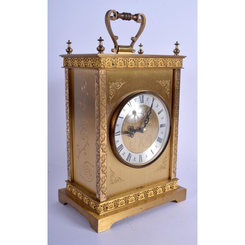 A BOXED JUNGHANS BRASS MANTEL CLOCK decorated with foliage. 20 cm