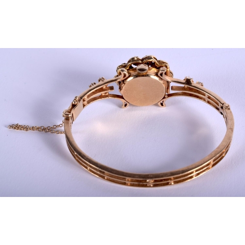 1820 - A GOOD 14CT GOLD LUCERNE BANGLE DIAMOND AND SAPPHIRE WRISTWATCH. 27.5 grams. 5.75 cm wide.