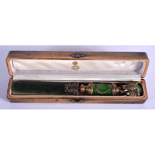 1952 - A BOXED CONTINENTAL SILVER GILT AND ENAMEL NEPHRITE JADE ELEPHANT PAPER KNIFE. 156 grams. 23 cm long... 