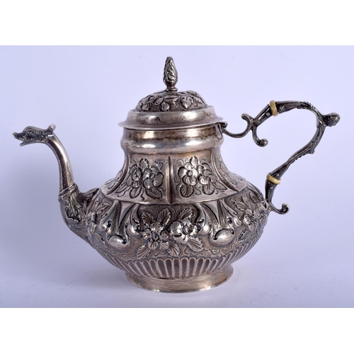 1974 - AN ANTIQUE CONTINENTAL SILVER TEAPOT decorated with foliage and vines. 442 grams. 17 cm x 13 cm.