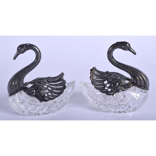 1977 - A PAIR OF SILVER AND CUT GLASS SWAN SALTS. 8 cm x 7 cm.