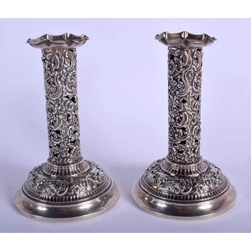 1990 - A PAIR OF ANTIQUE OPENWORK SILVER CANDLESTICKS. London. 499 grams possibly weighted. 15 cm high.