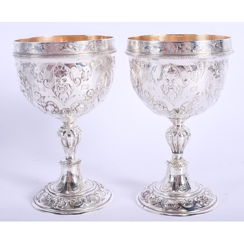 2047 - AN ANTIQUE CONTINENTAL SILVER DOUBLED ENDED STACKING CUPS possibly for wagering, decorated with putt... 