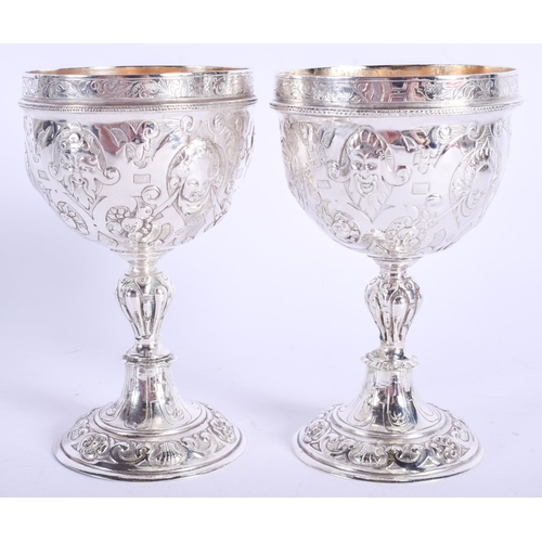 2047 - AN ANTIQUE CONTINENTAL SILVER DOUBLED ENDED STACKING CUPS possibly for wagering, decorated with putt... 