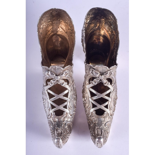 2055 - A RARE LARGE PAIR OF 19TH CENTURY CONTINENTAL SILVER SHOES decorated with flowers and scrolling moti... 