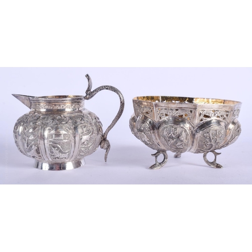 2056 - AN ANTIQUE INDIAN SILVER CREAM JUG and matching sugar basin. 182 grams. (2)