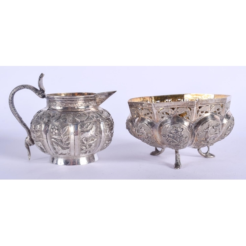 2056 - AN ANTIQUE INDIAN SILVER CREAM JUG and matching sugar basin. 182 grams. (2)