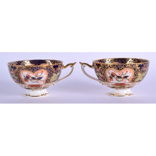 209 - Royal Crown Derby pair of pedestal teacups and saucers painted with imari pattern 9022.