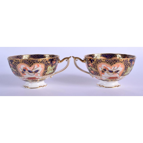 210 - Royal Crown Derby pair of pedestal teacups and saucers painted with imari pattern 9022