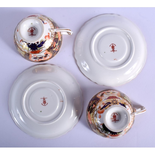 210 - Royal Crown Derby pair of pedestal teacups and saucers painted with imari pattern 9022