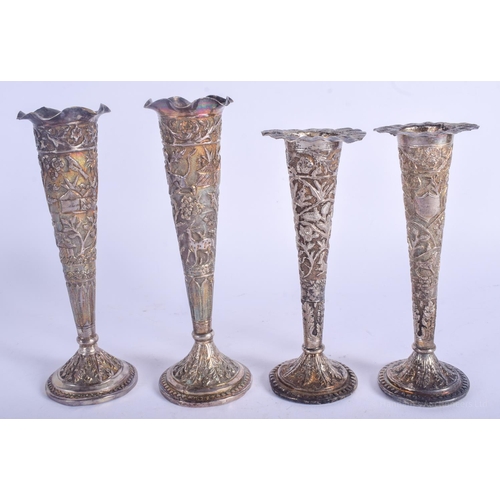 2104 - FOUR ANTIQUE MIDDLE EASTERN INDIAN SILVER VASES decorated with foliage. 918 grams loaded. Largest 18... 