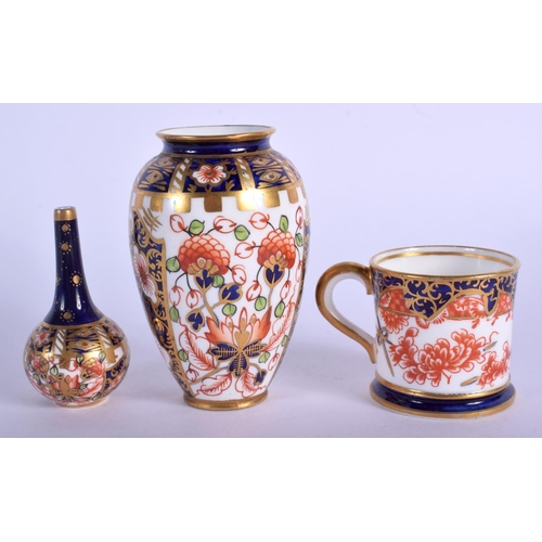 211 - Royal Crown Derby imari pattern 6299 small vase, a bottle vase in the same pattern and a 26469 minia... 