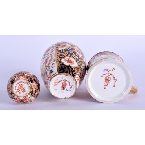 211 - Royal Crown Derby imari pattern 6299 small vase, a bottle vase in the same pattern and a 26469 minia... 