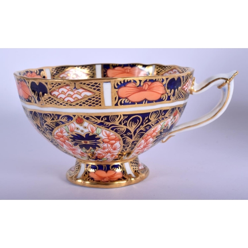 213 - Royal Crown Derby pedestal teacup and saucer painted with imari pattern 1128.