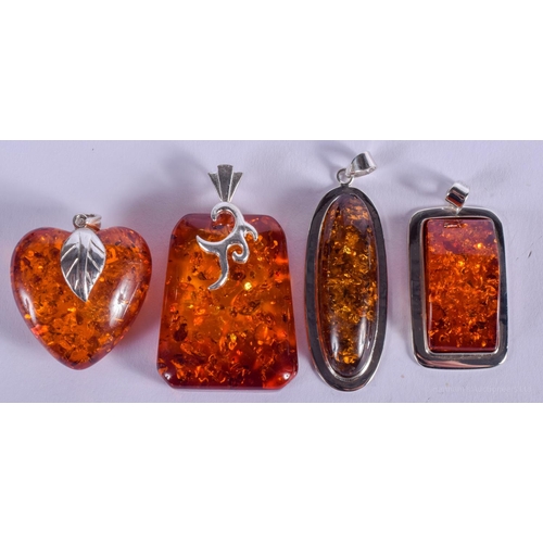 2157 - FOUR SILVER AND AMBER PENDANTS. (4)