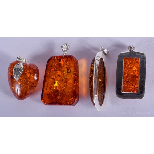 2157 - FOUR SILVER AND AMBER PENDANTS. (4)