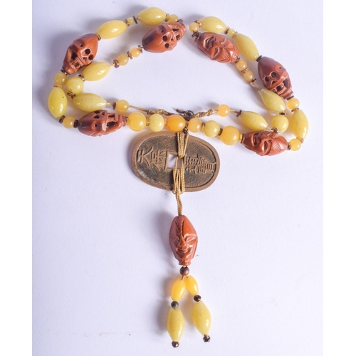 2163 - AN EARLY 20TH CENTURY SOUTH EAST ASIAN NUT AND GLASS NECKLACE. 40 cm long.