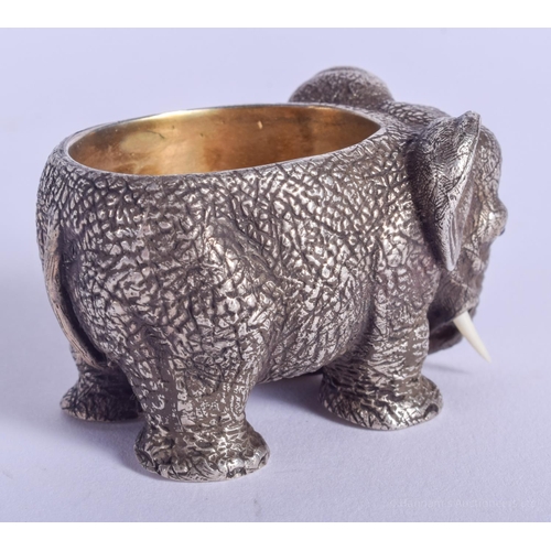 2170 - A CONTINENTAL SILVER ELEPHANT SALT with ruby eyes. 157 grams. 4.5 cm x 3 cm.