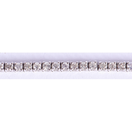 2219 - A FINE 18CT GOLD AND DIAMOND TENNIS BRACELET. 15.2 grams. 18 cm x 0.4 cm.