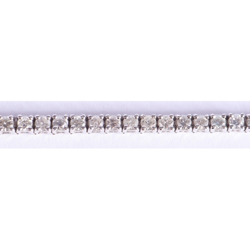 2219 - A FINE 18CT GOLD AND DIAMOND TENNIS BRACELET. 15.2 grams. 18 cm x 0.4 cm.