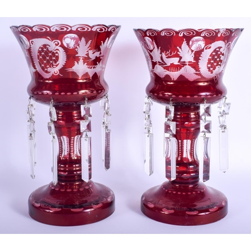 24 - A PAIR OF ANTIQUE CRANBERRY GLASS LUSTRES decorated with hunting scenes. 31 cm high.