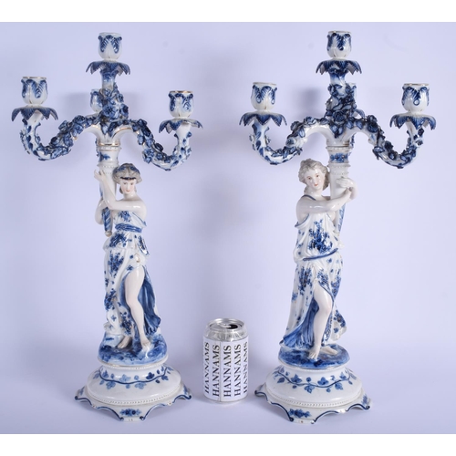 258 - A LARGE PAIR OF ANTIQUE GERMAN BLUE AND WHITE PORCELAIN CANDELABRA painted with foliage. 61 cm x 18 ... 