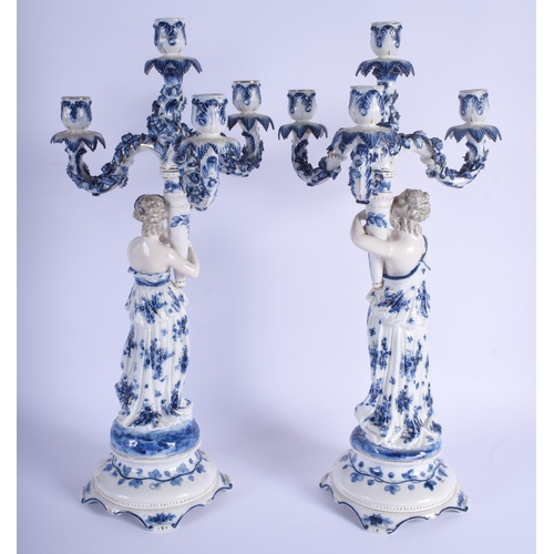 258 - A LARGE PAIR OF ANTIQUE GERMAN BLUE AND WHITE PORCELAIN CANDELABRA painted with foliage. 61 cm x 18 ... 