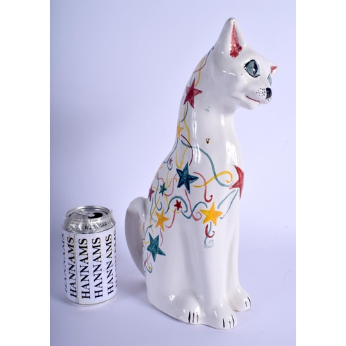 284 - A LARGE BRANNAM FIGURE OF A CAT painted with stars. 34 cm x 16 cm.