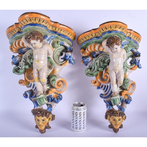 294 - A LARGE PAIR OF 19TH CENTURY FRENCH FAIENCE GLAZED MAJOLICA BRACKET formed with putti amongst foliag... 