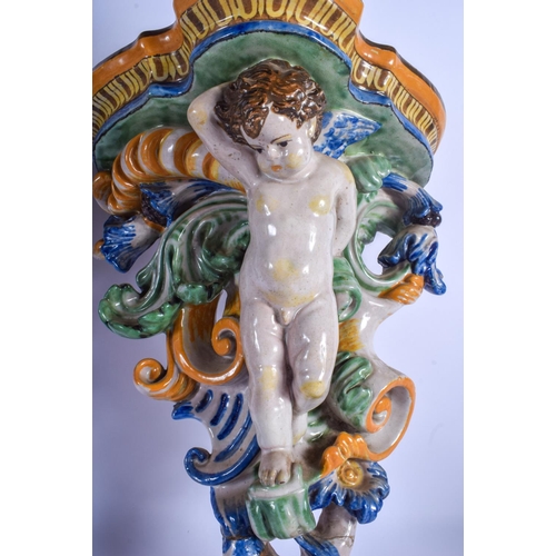 294 - A LARGE PAIR OF 19TH CENTURY FRENCH FAIENCE GLAZED MAJOLICA BRACKET formed with putti amongst foliag... 