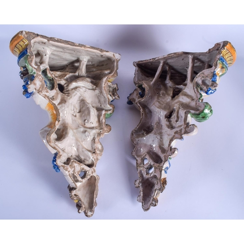 294 - A LARGE PAIR OF 19TH CENTURY FRENCH FAIENCE GLAZED MAJOLICA BRACKET formed with putti amongst foliag... 