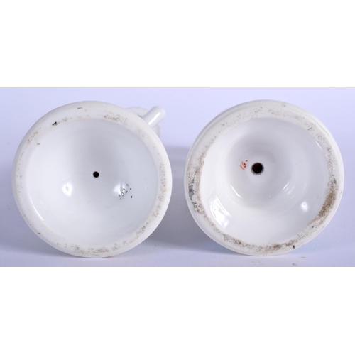 299F - A PAIR OF 19TH CENTURY EUROPEAN PORCELAIN CANDLESTICKS together with a Derby or Coalport stand, mode... 