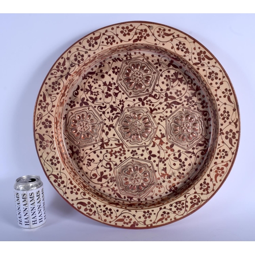 299B - A VERY LARGE SPANISH VALENCIA HISPANO MORESQUE POTTERY DISH decorated with floral roundels and motif... 