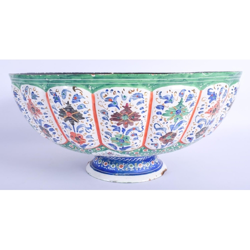 301 - A LARGE MIDDLE EASTERN PERSIAN ENAMELLED TIN BOWL painted with flowers and a river scene. 34 cm x 15... 