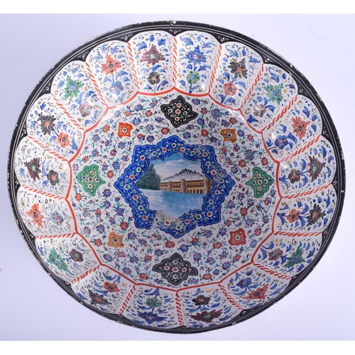 301 - A LARGE MIDDLE EASTERN PERSIAN ENAMELLED TIN BOWL painted with flowers and a river scene. 34 cm x 15... 