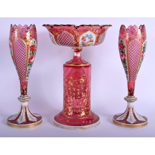 32 - A 19TH CENTURY BOHEMIAN CRANBERRY GLASS GARNITURE enamelled with a portrait of a female, the vases o... 